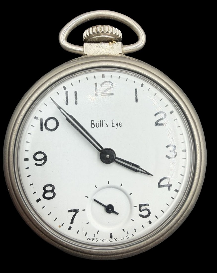 Gorgeous Vintage BULLS EYE Silver-Tone Metal & White Dial Pocket Watch: Very good vintage condition with minor patina according to age. Dial measures approx. 1 1/2" long and 1 1/2" wide and weighs ca. 38.2 grams. Marked for BULLS EYE. The timepiece is functional.