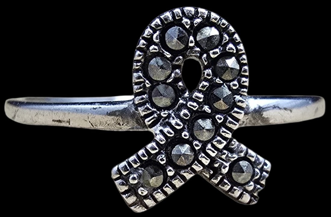 Ornate Vintage Sterling Silver & Macarsite Awareness Ring: Very good vintage condition with minor patina according to age. The ring is a size 6 and weighs ca. 1 gram. Marked for Sterling Silver.