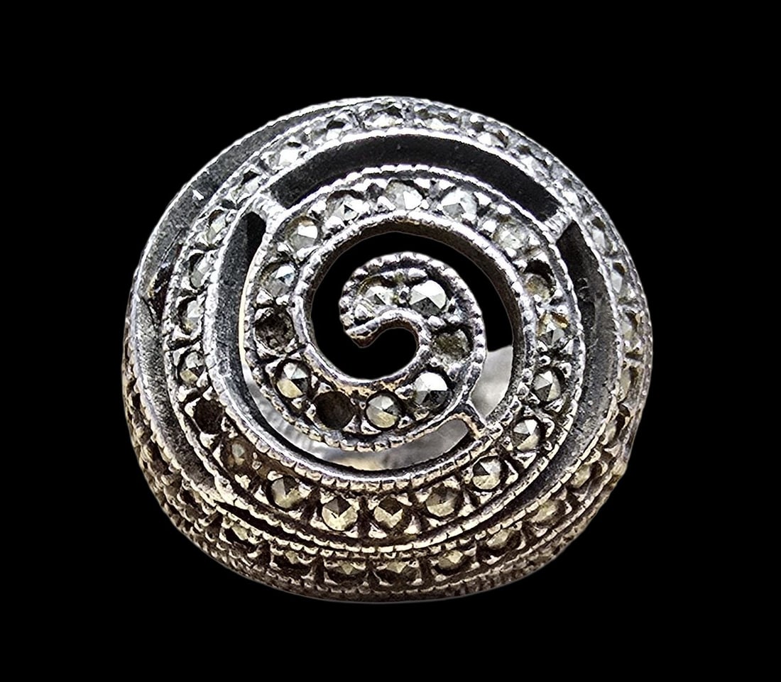 Beautiful Ornate Vintage Sterling Silver /w Macarsite Ring: Very good vintage condition with minor patina according to age. Measures approx. ?" long and ?" wide and weighs ca. 8 grams. The ring is a size 4.5. Marked for Sterling Silver. Missing Some Macarsite.