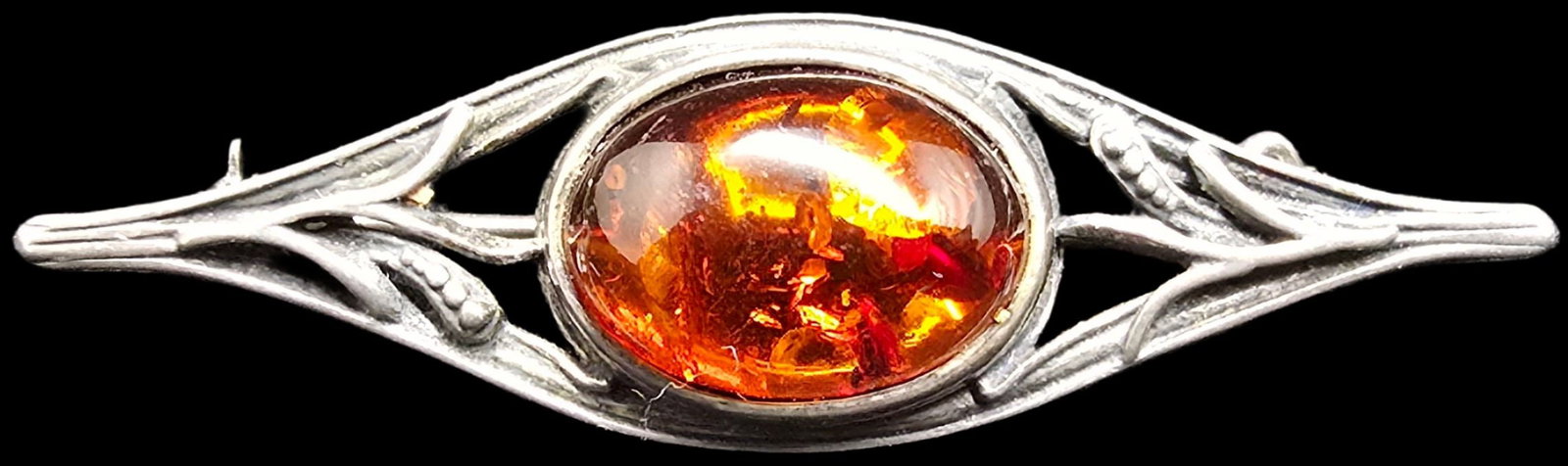 Beautiful Vintage Sterling Silver & Baltic Amber Brooch: Very good vintage condition with minor patina according to age. Measures approx. 2" long and weighs ca. 3.5 grams. Tested for Sterling Silver.