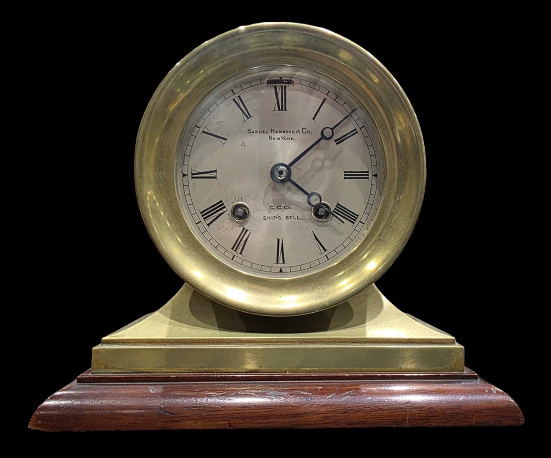 Antique SAMUEL HAMMOND & CHELSEA CLOCK CO. Ship's Clock w/ Chime: An early 20th-century solid forged brass Chelsea Ship's Bell clock, featuring a silvered metal dial co-signed by retailer Samuel Hammond & Co. New York and C.C.Co. (Chelsea Clock Co.), mounted on a st