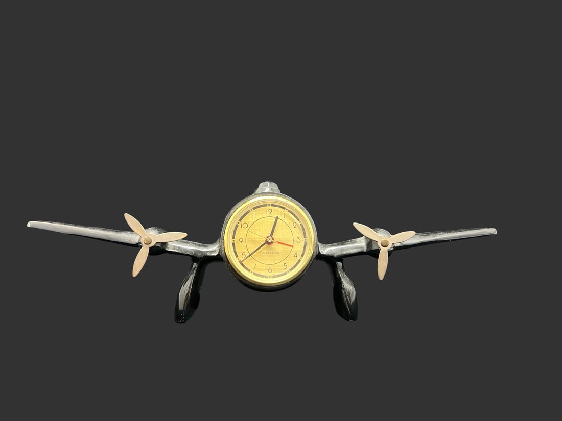 Stunning Vintage SARSAPARILLA Art Deco Cast Aluminum Plane Figurine Quarz Table Quartz Clock: Very good vintage condition; no cracks or repairs; one wing has a small chip. Measures approx. 2 3/4" long and 13 1/2" wide and 4" high. Marked for SARSAPARILLA.