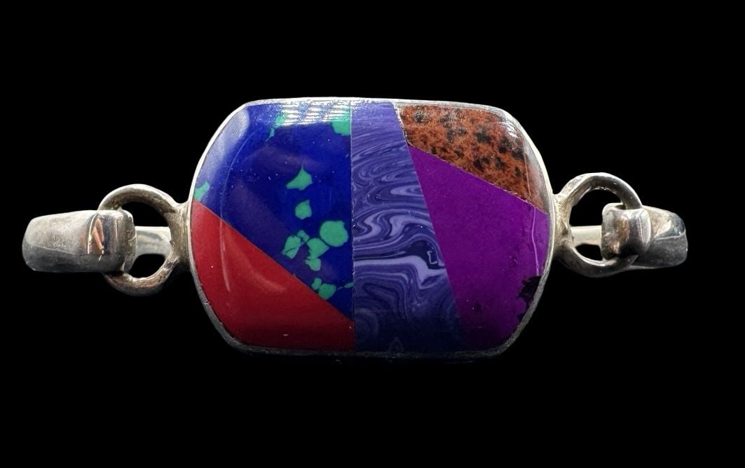 Stunning Vintage Mexican Sterling Silver & Inlaid Multi-Color Gemstone Bracelet: Very good vintage condition with minor patina according to age. Measures approx. 2 1/2" long and 2 3/4" wide and weighs ca. 35 grams. Marked for Sterling Silver.