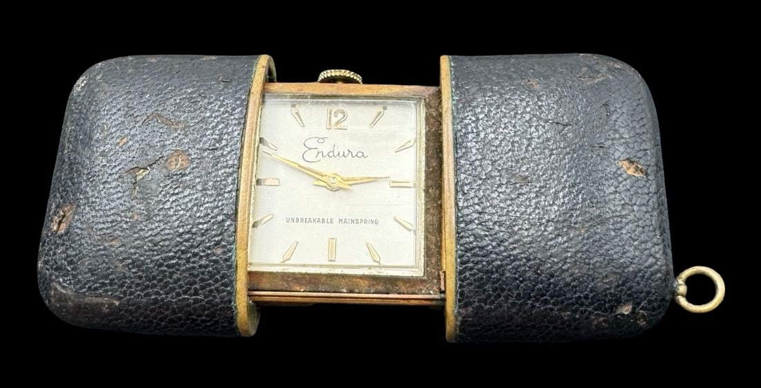 Vintage 1960s ENDURA Germany Gold-Tone Travel Clock: Very good vintage condition with minor patina according to age. Measures approx. 2" long x 1 1/2" wide. Made in Germany.