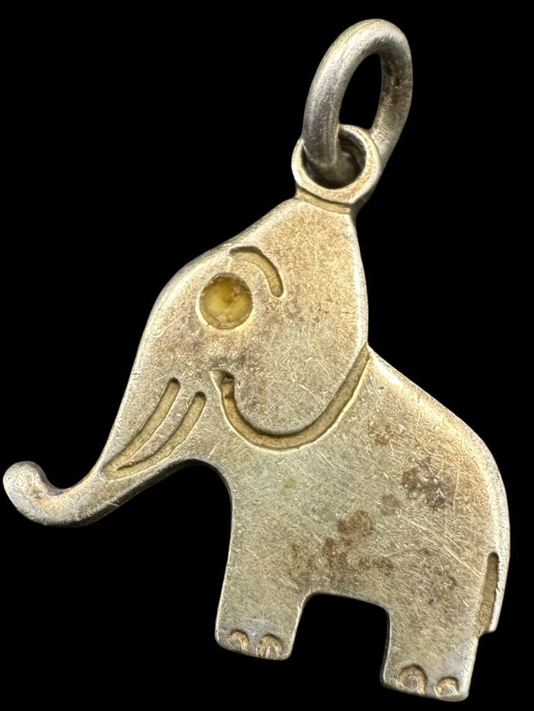 Whimsical Vintage Sterling Silver Elephant Pendant Charm: Very good vintage condition with minor patina according to age. Measures approx. 3/4" long x 5/8" wide and weighs ca. 1.3 grams. Marked for Sterling Silver.