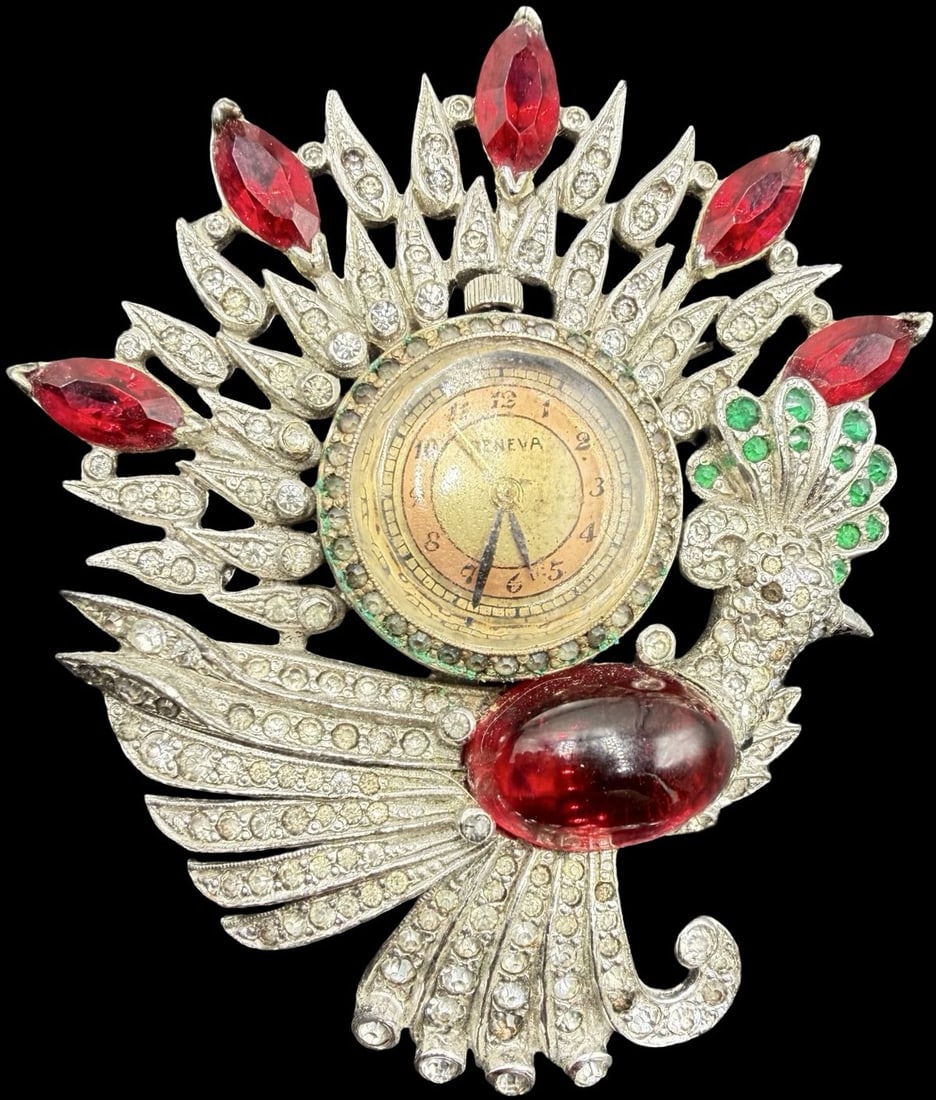 Stunning Vintage Art Deco GENEVA Multi-Colored Rhinestone Watch Brooch: Very good vintage condition with minor patina according to age; watch doesn't work. Measures approx. 2 1/2" long x 2" wide and weighs ca. 38 grams.