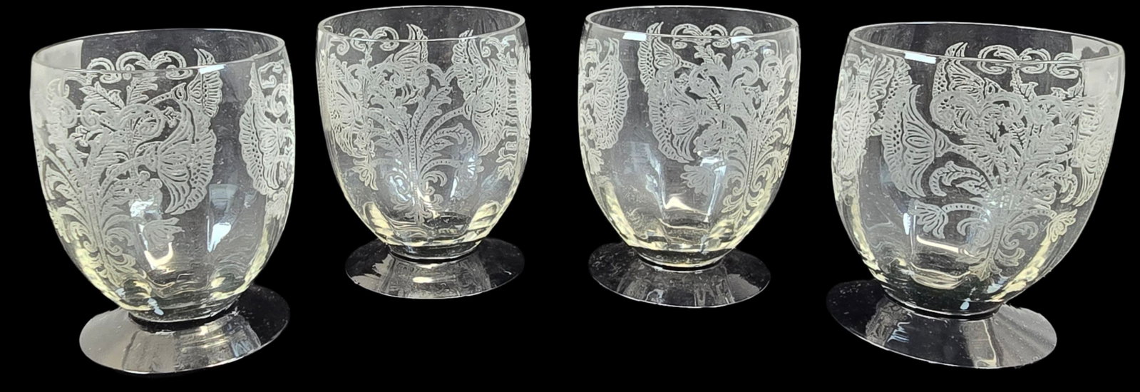 Set of 4 Vintage Engraved Crystal Glasses w/ Black Bases: Very good vintage condition; no chips, cracks, or repairs. Each measures approx. 3" high x 2 1/2" in diameter.