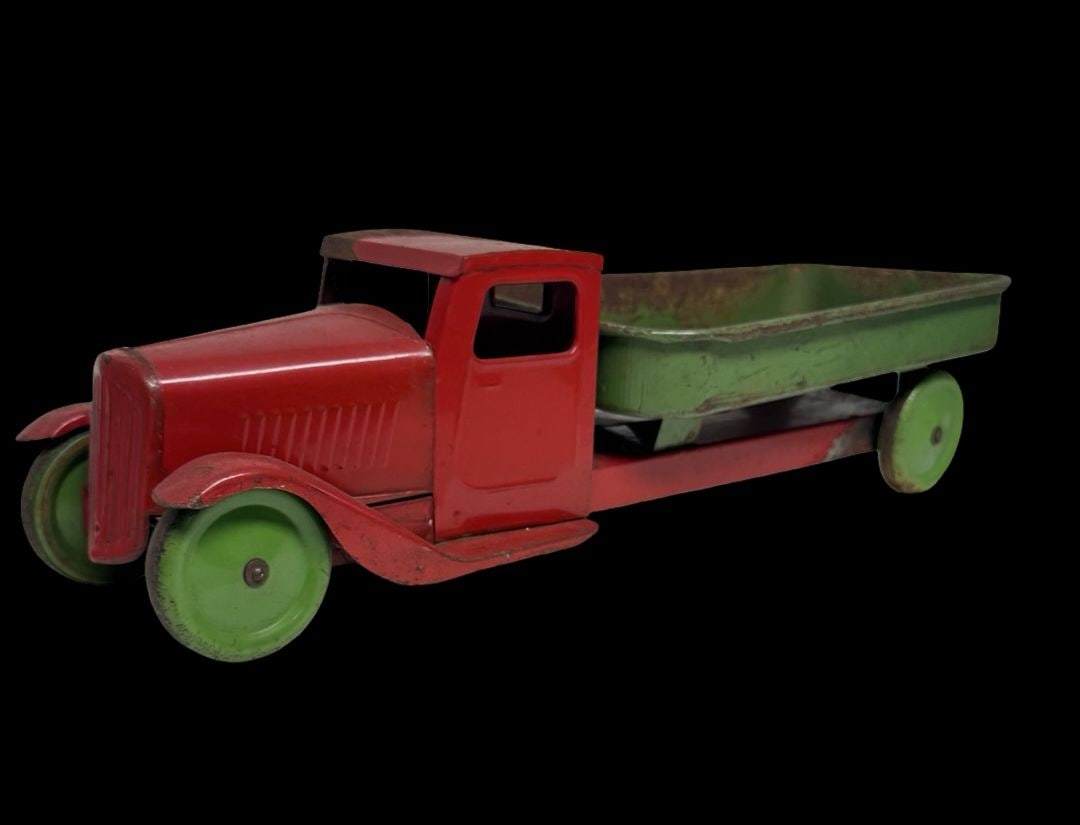 Antique Ca. 1930s STEELCRAFT Pressed Steel Dump Truck Toy: Good antique condition with wear and patina according to use and age, please see pictures. Measures approx. 22" long and 7" wide and 6" high.