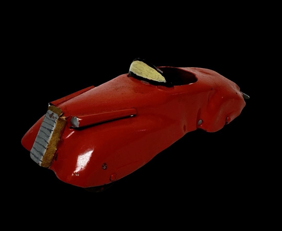 Vintage Pressed Steel Red Roadster Streamline Car Toy: Good antique condition with wear and patina according to use and age, please see pictures. Missing one wheel. Measures approx. 6" long and 2" wide and 2" high.