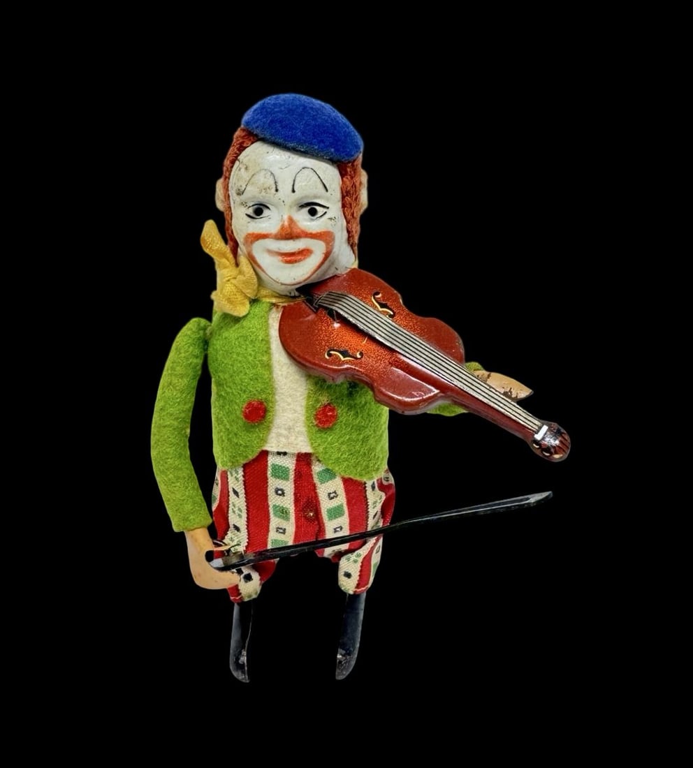 Vintage Ca. 1930s SCHUCO Germany Violin Playing Clown Wind-Up Toy: Good vintage condition with wear and patina according to use and age, please see pictures. Measures approx. 1 1/2" long and 1" wide and 4 1/2" high.