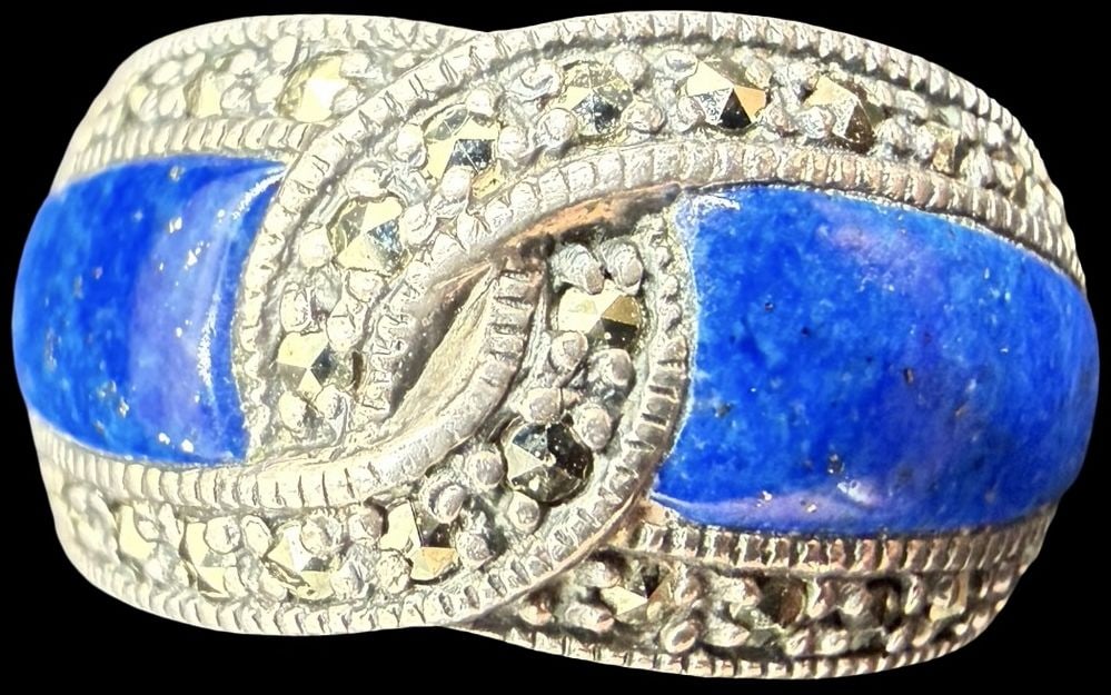 Ornate Vintage Gilt Sterling Silver Ring w/ Marcasite & Two Blue Gemstones: Good vintage condition w/ patina and wear according to age and use, see pictures. Measures approx. 1" long and 1/2" wide and weighs ca. 8.9 grams. The Ring is Size 5 1/2. Marked Sterling Silver.