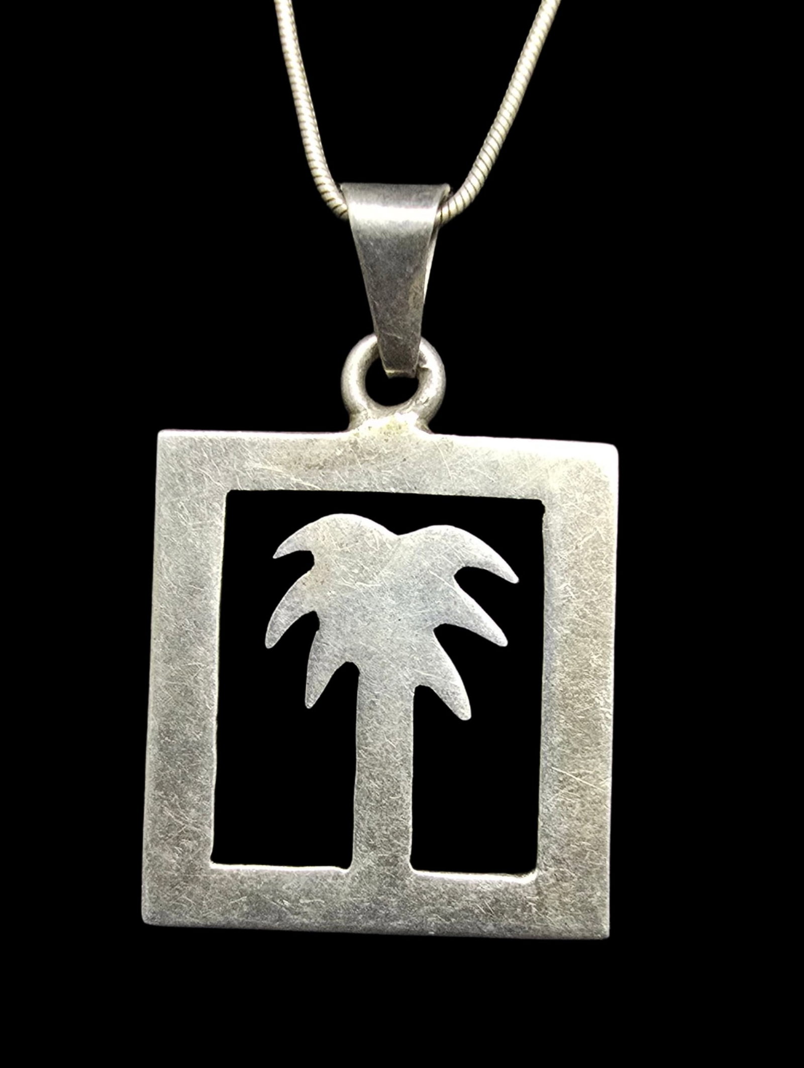 Beautiful Vintage Sterling SilverPalm Tree Cut Out Pendant Necklace: Good vintage condition w/ patina and wear according to age and use, see pictures. Weighs ca. 13 grams. Necklace is 20" long. Marked Sterling Silver