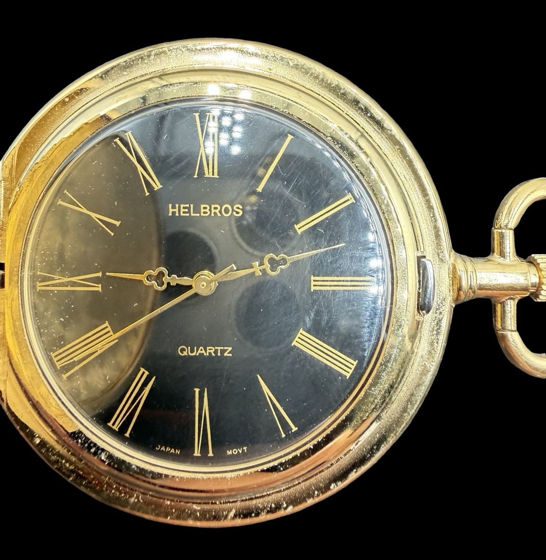Ornate Vintage HELBROS Gold-Tone Metal & Black Dial Quartz Pocket Watch: Good vintage condition w/ patina and wear according to age and use, see pictures. Dial measures approx. 1" long and 1" wide and weighs ca. 32.6 grams. Marked for HELBROS. Requires new batteries, untes