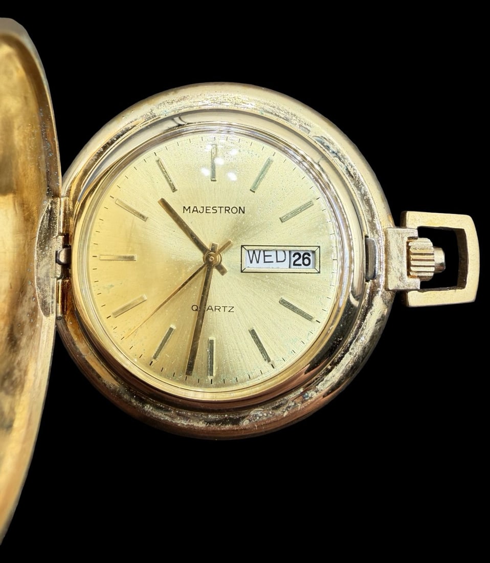 Vintage MAJESTRON Gold-Tone Metal Quartz Pocket Watch: Good vintage condition w/ patina and wear according to age and use, see pictures. Dial measures approx. 1" long and 1" wide and weighs ca. 43.6 grams. Marked for MAJESTRON. Requires batteries, unteste