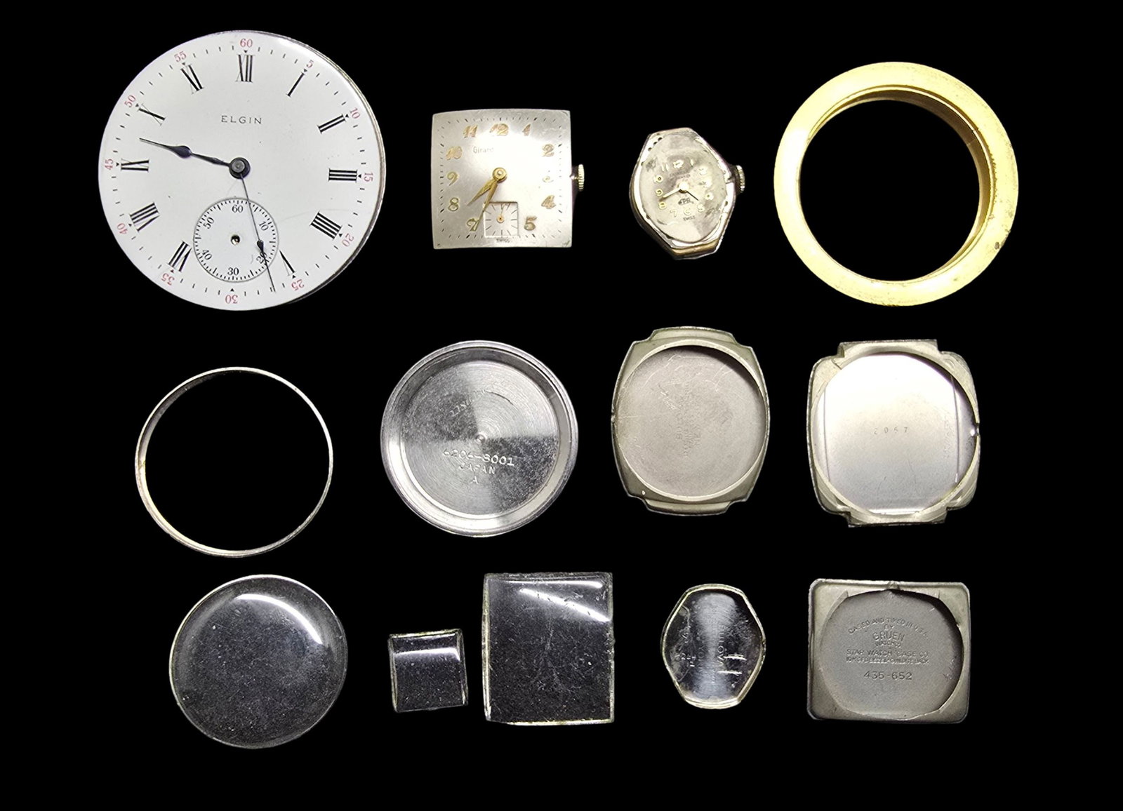Lot of Vintage Watch Movements & Watch Parts: Good vintage condition w/ patina and wear according to age and use, see pictures. The largest piece measures approx. 2" high and 2" wide and the entire lot weighs ca. 90 grams.