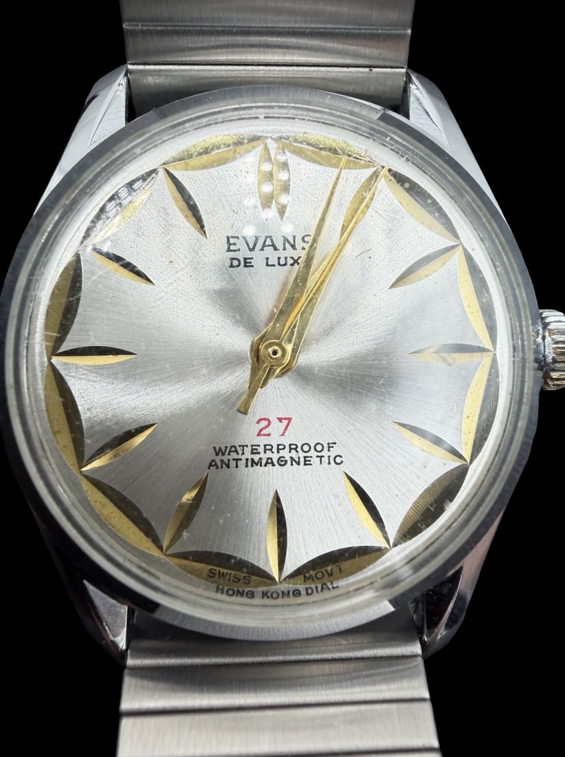 Vintage EVANS De Luxe Gold-Tone Stainless Steel Ladies Watch: Good vintage condition w/ patina and wear according to age and use, see pictures. Dial measures approx. 1 1/4" long and 1 1/4" wide and weighs ca. 55.19 grams. Marked for EVANS. The timepiece is worki