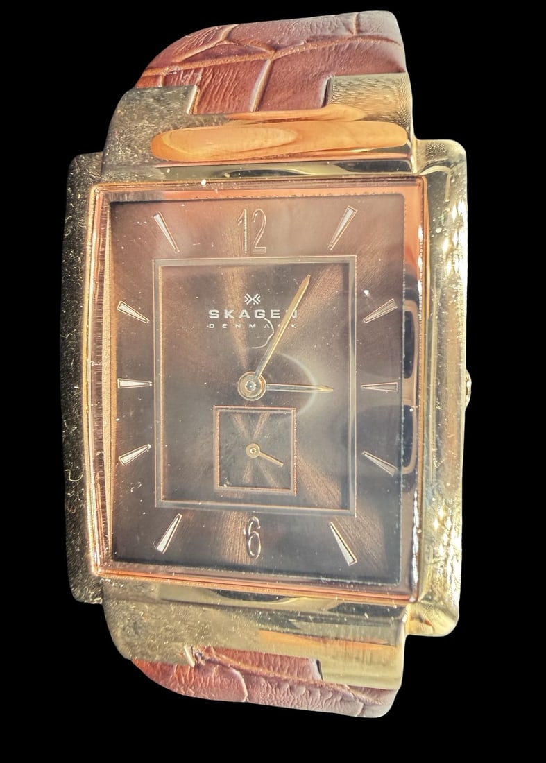 Vintage SKAGEN Denmark Stainless Steel & Brown Leather Strap Watch w/ Box: Good vintage condition w/ patina and wear according to age and use, see pictures. Dial measures approx. 1 1/2" long and 3/4" wide and weighs ca. 38.6 grams. Marked for SKAGEN. The timepiece is functio