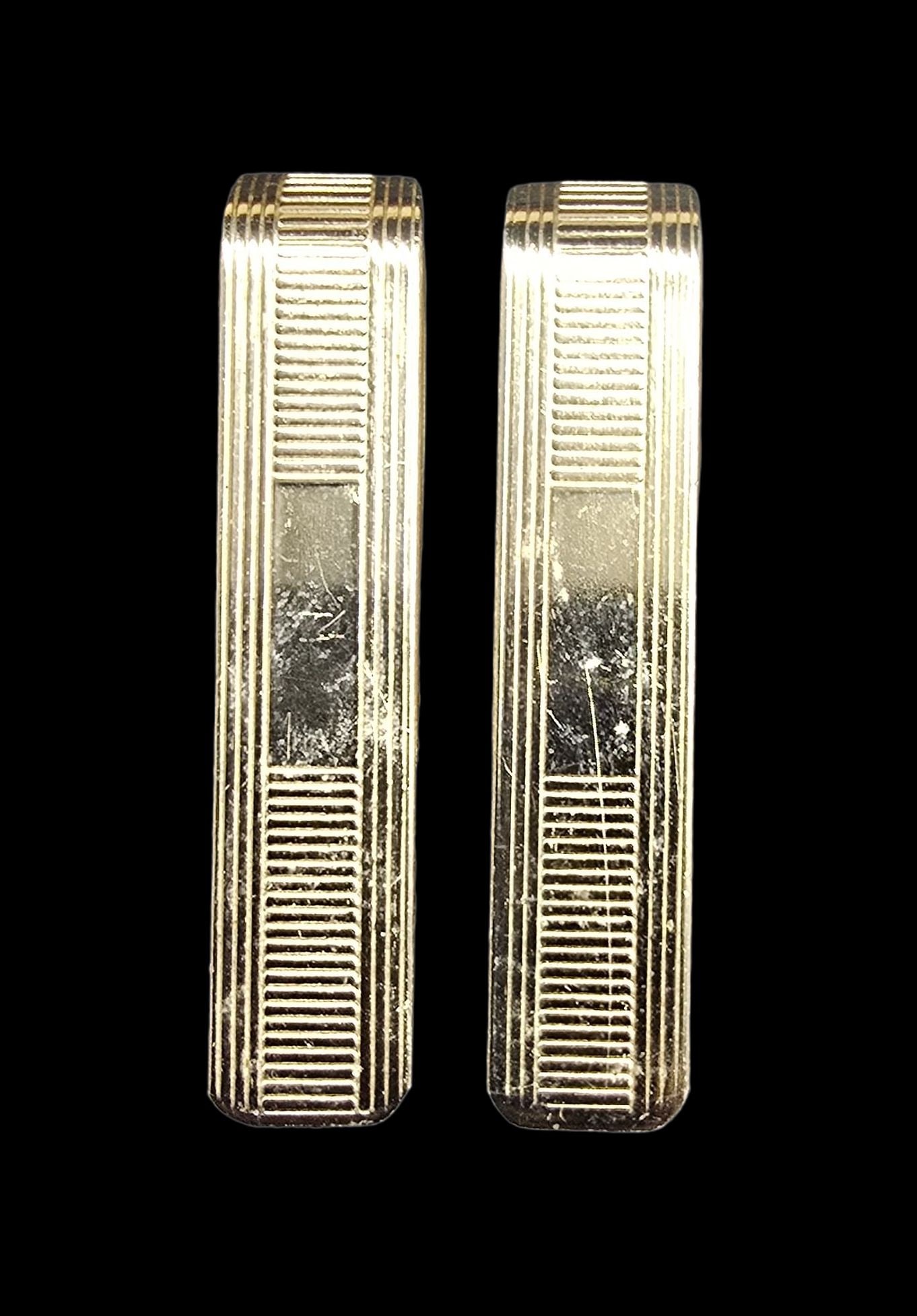 Pair of Stylish Vintage PAUL CARVER Gold Filled Money Clips: Good vintage condition w/ patina and wear according to age and use, see pictures. Measures approx. 1 1/2" long and 1/2" wide and weighs ca. 5.5 grams. Marked for Gold Filled