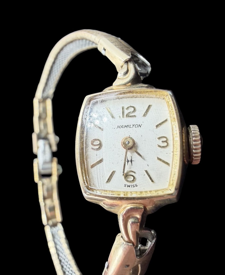 Vintage Mid-Century HAMILTON 10K Gold Filled Ladies Wristwatch: Good vintage condition w/ patina and wear according to age and use, see pictures. Dial measures approx. 1/2" long and 1/2" wide and weighs ca. 13.14 grams. Marked for HAMILTON. The timepiece is curren