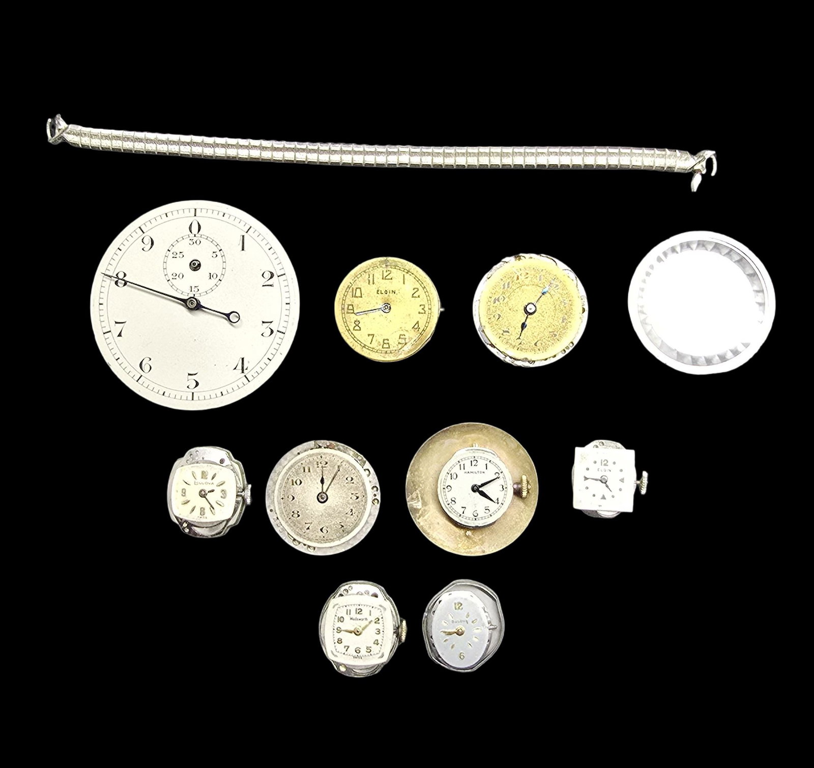 Lot of Watch Movements & Watch Parts: Good vintage condition w/ patina and wear according to age and use, see pictures. The largest piece measures approx. 2" high and 2" wide and the entire lot weighs ca. 98 grams.