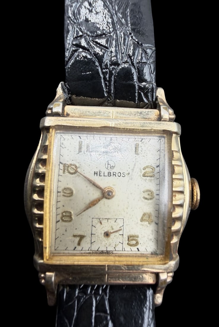 Vintage Mid-Century HELBROS Gold Filled & Black Leather Strap Wristwatch: Good vintage condition w/ patina and wear according to age and use, see pictures. Dial measures approx. 3/4" long and 3/4" wide and weighs ca. 27.01 grams. Untested. Marked for HELBROS.