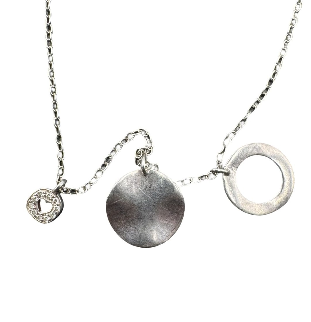 Charming IPPOLITA Sterling Silver Wavy Disc Multi-Pendant Heart Charm Necklace: Very good vintage condition with minor patina according to age. Necklace measures approx. 19" long and the pendants measure approx. 1/2 long" x 1/4" wide. Weighs ca. 2.57 grams. Marked for Sterling Si