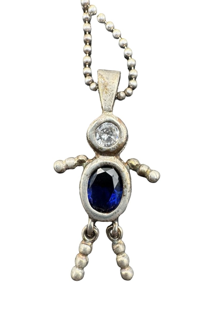 Whimsical Vintage Sterling Silver Articulated Boy Ragdoll Blue Glass Pendant Necklace: Very good vintage condition with minor patina according to age. Necklace measures approx. 22" long and the pendant measures approx. 1 1/4 long" x 1/2" wide. Weighs ca.5.8 grams. Marked for Sterling Si