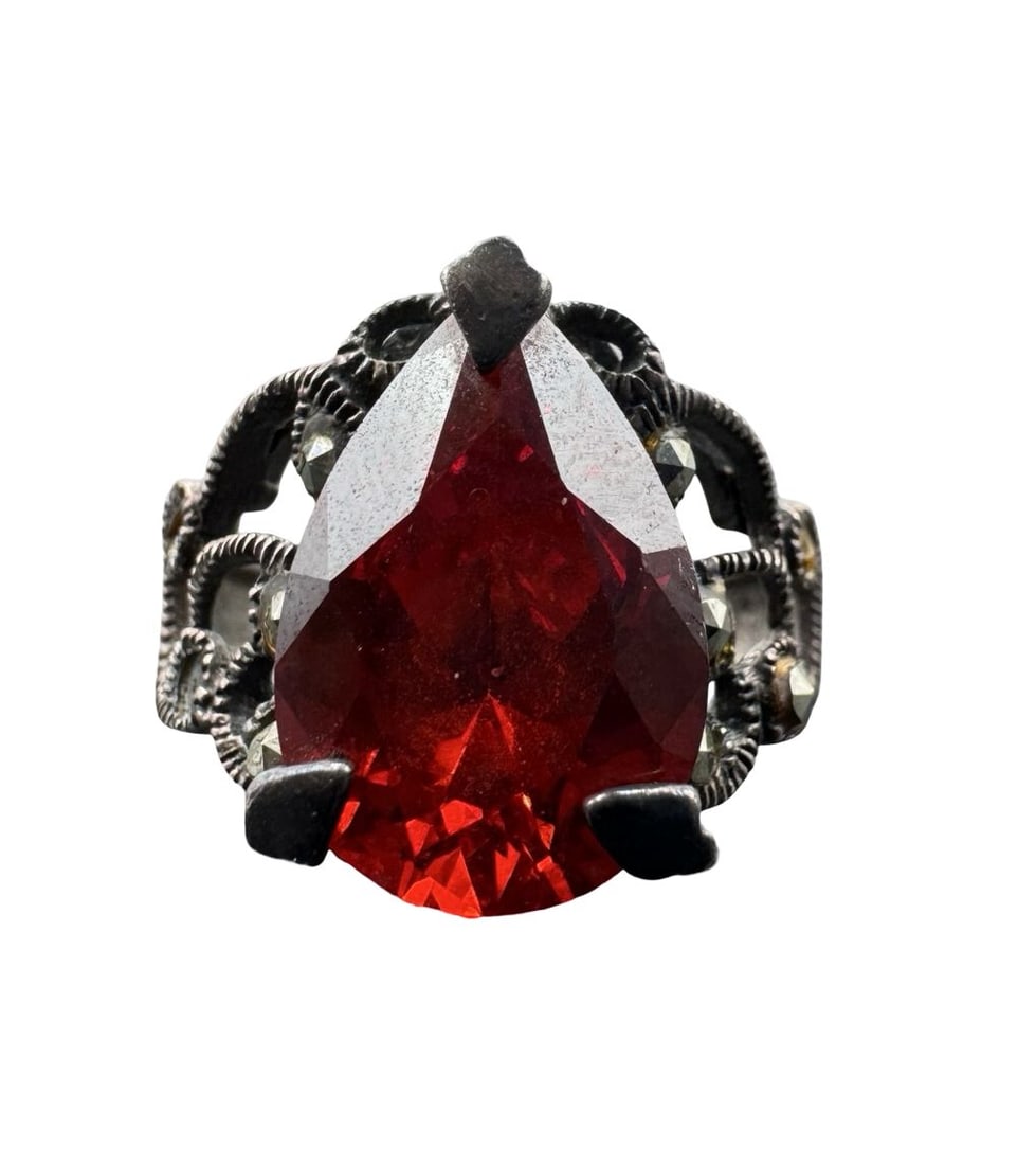 Enchanting Vintage Sterling Silver, Marcasite & Pear-Cut Red Gemstone Filigree Ring: Very good vintage condition with minor patina according to age. Measures approx. 1" long and 3/4" wide and weighs ca. 5.79 grams. The ring is a size 6.5. Marked for Sterling Silver.