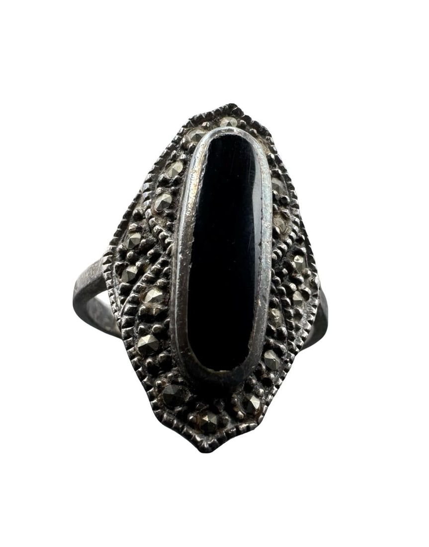 Elegant Vintage Sterling Silver, Marcasite & Black Onyx Cabochon Ring: Very good vintage condition with minor patina according to age. Measures approx. 1" long and 7/8" wide and weighs ca. 5.36 grams. The ring is a size 9.5. Marked for Sterling Silver.