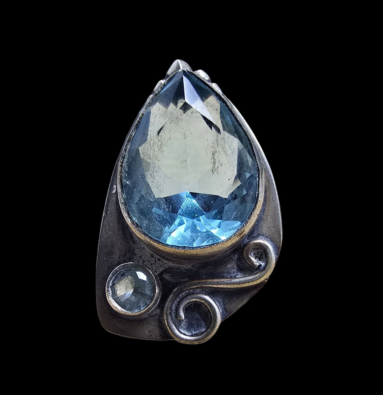 Gorgeous Vintage Sterling Silver & Blue Gemstone Cocktail Ring: Very good vintage condition with minor patina according to age. Measures approx. 1/2" wide and weighs ca. 6 grams. The ring is a size 7. Marked for Sterling Silver.