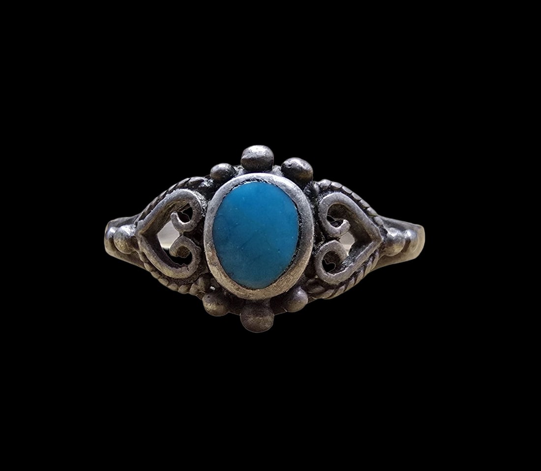 Beautiful Ornate Vintage Sterling Silver & Blue Gemstone Ring: Very good vintage condition with minor patina according to age. The ring is a size 5 and weighs ca. 1.5 grams. Marked for Sterling Silver.
