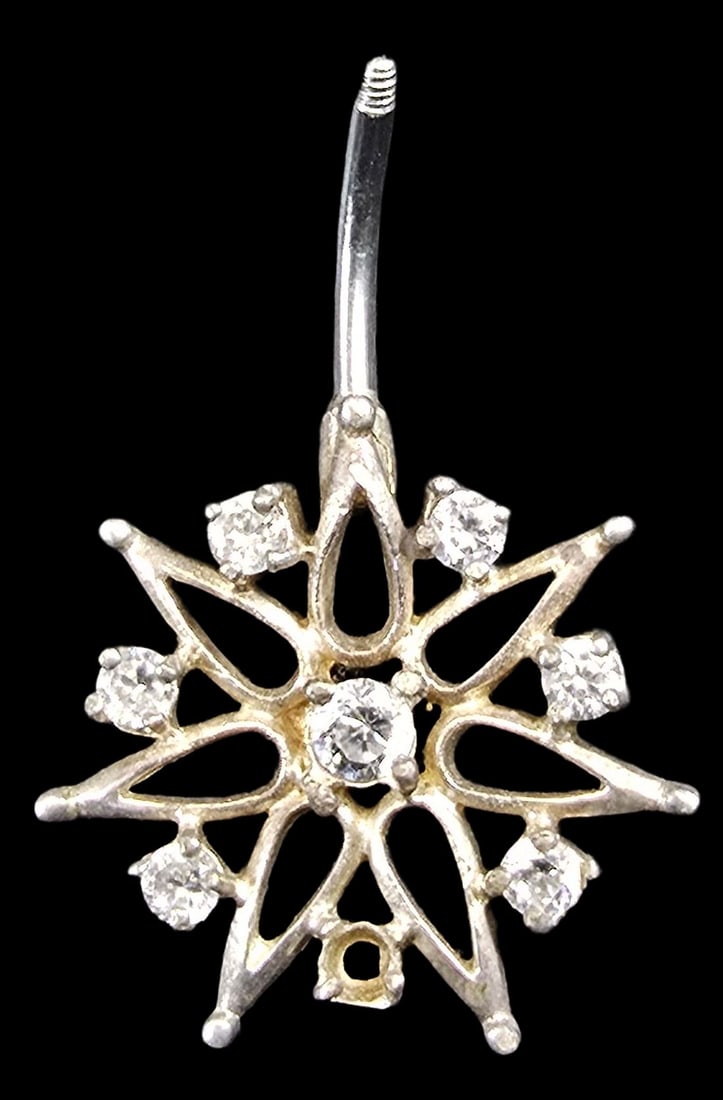 Vintage Partially Gilt Sterling Silver & Clear Rhinestone Star-Shaped Pendant: Good vintage condition with minor patina according to age; missing one gemstone. Measures approx. 1 1/2" high x 1" wide and weighs ca. 3 grams.