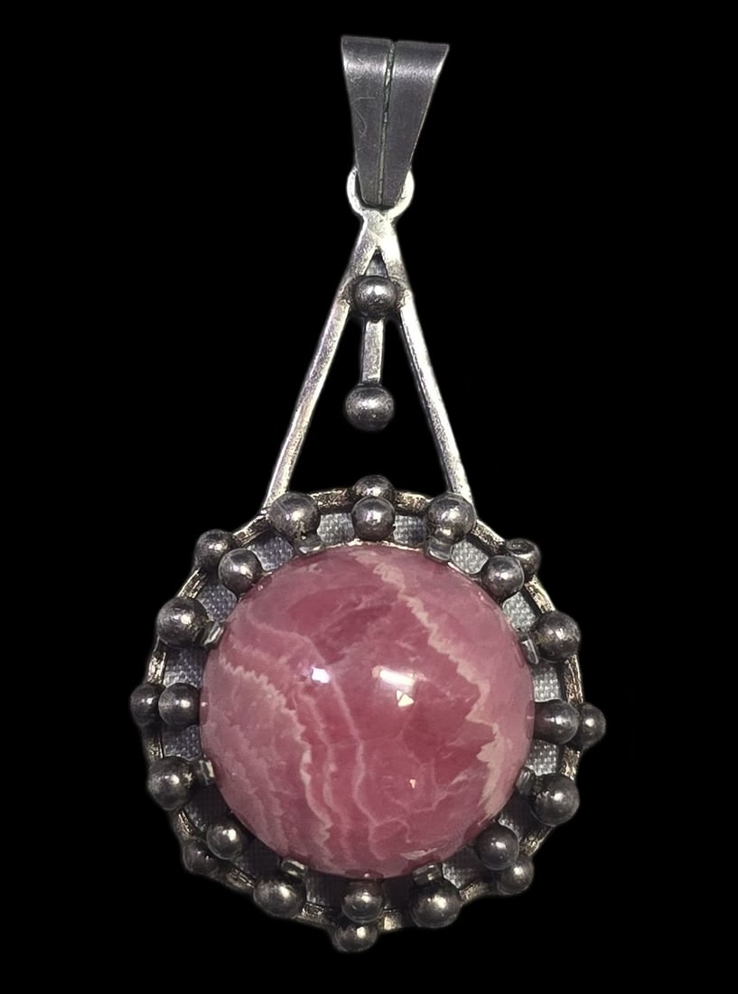 Stylish Vintage Mid-Century Modern Sterling Silver & Rhodochrosite Pendant: Very good vintage condition with minor patina and wear according to age. Measures approx. 2" long x 1" wide and weighs ca. 10.5 grams. Marked for Sterling Silver..