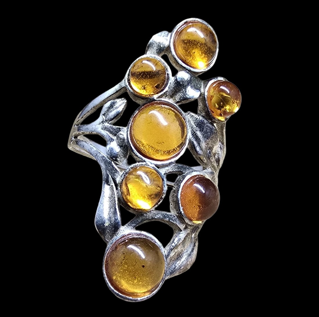 Very Unusual Vintage Mid-Century Sterling Silver & Amber Ring: Very good vintage condition with minor patina according to age. Measures approx. 1 1/2" long and 1/2" wide and weighs ca. 3.5 grams. The ring is a size 6.5. Marked for Sterling Silver.