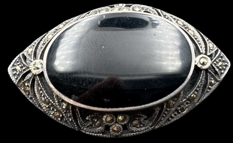 Stylish Vintage Sterling Silver, Black Onyx & Marcasite Brooch: Very good vintage condition with minor patina according to age. Measures approx. 1 1/8" long x 1" wide and weighs ca. 7.7 grams. Marked for Sterling Silver..