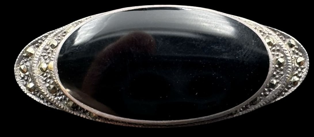 Vintage Sterling Silver, Black Onyx & Marcasite Brooch: Very good vintage condition with minor patina according to age. Measures approx. 1 3/4" long x 3/4" wide and weighs ca. 7.7 grams. Marked for Sterling Silver..