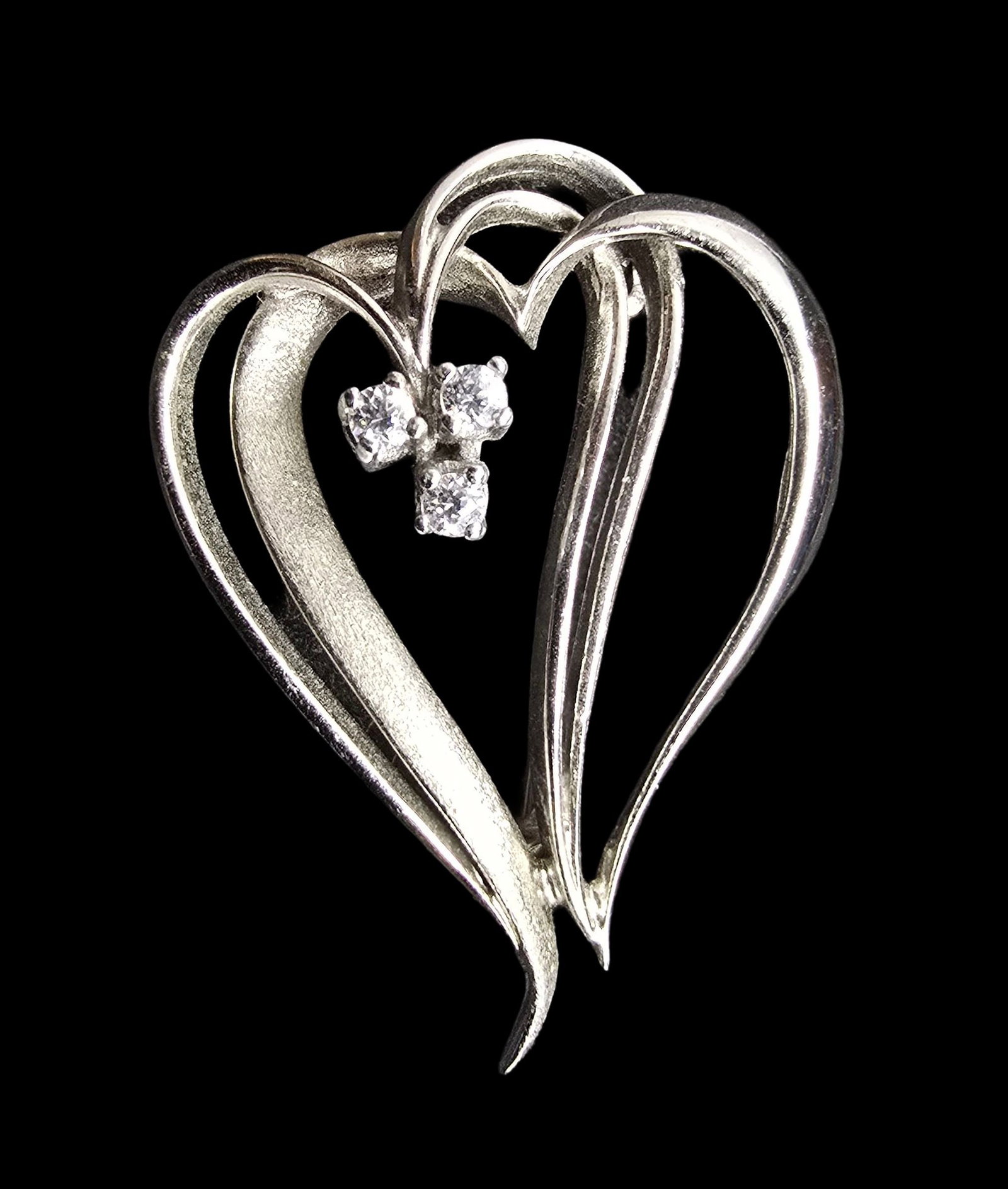 Gorgeous Vintage Sterling Silver & Clear Rhinestone Two Hearts Brooch: Very good vintage condition with minor patina according to age. Weighs ca. 3 grams. Marked for Sterling Silver.