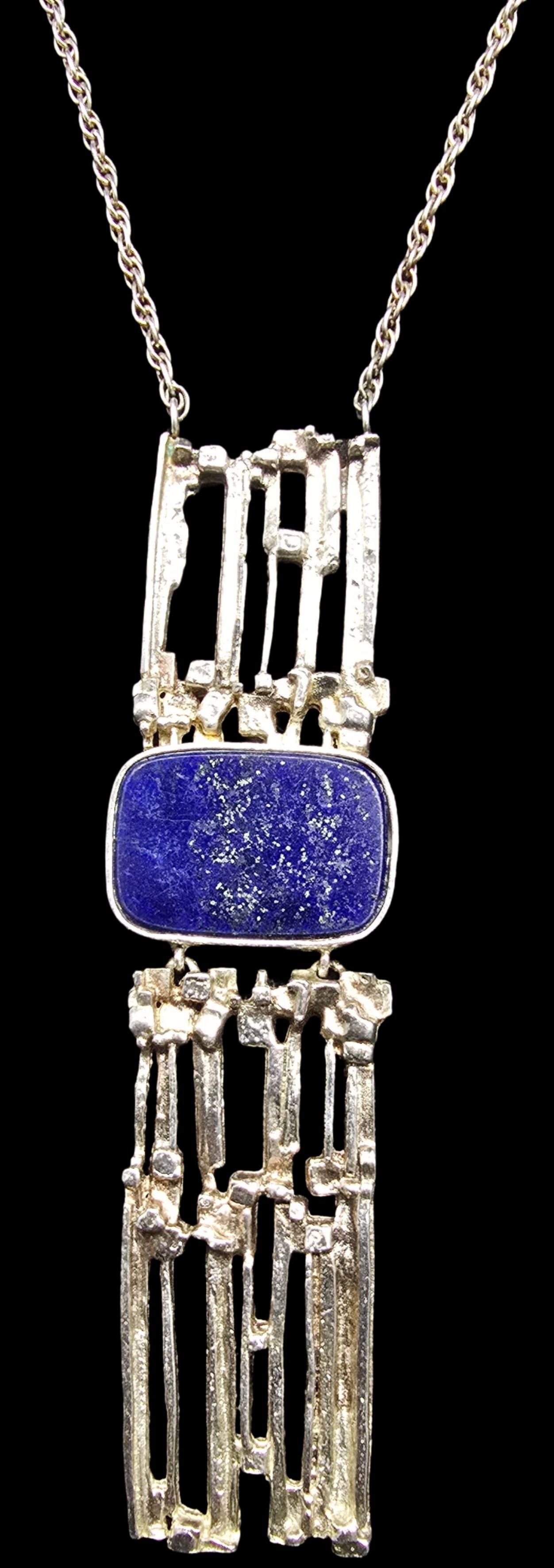 Gorgeous Vintage Mid-Century Modern Brutalist Sterling Silver & Lapis Lazuli Pendant Necklace: Very good vintage condition with minor patina according to age. Pendant measures approx. 1" wide and total weight is ca. 33 grams. The necklace is approx. 35" long. Marked for Sterling Silver.