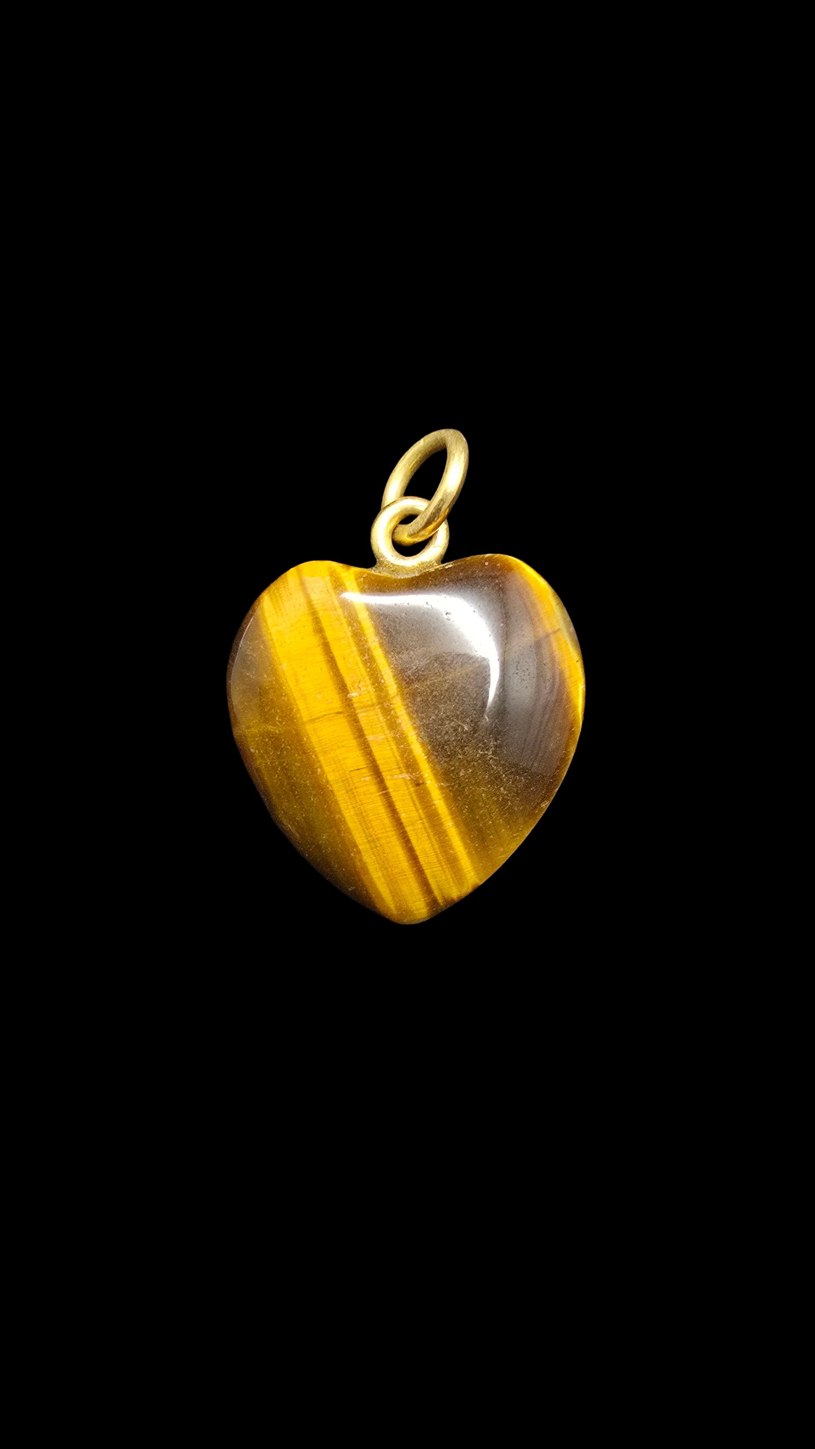 Beautiful Vintage Tiger's Eye Heart Pendant: Very good antique condition with minor patina according to age. Measures approx. 1" wide and weighs ca. 3 grams.