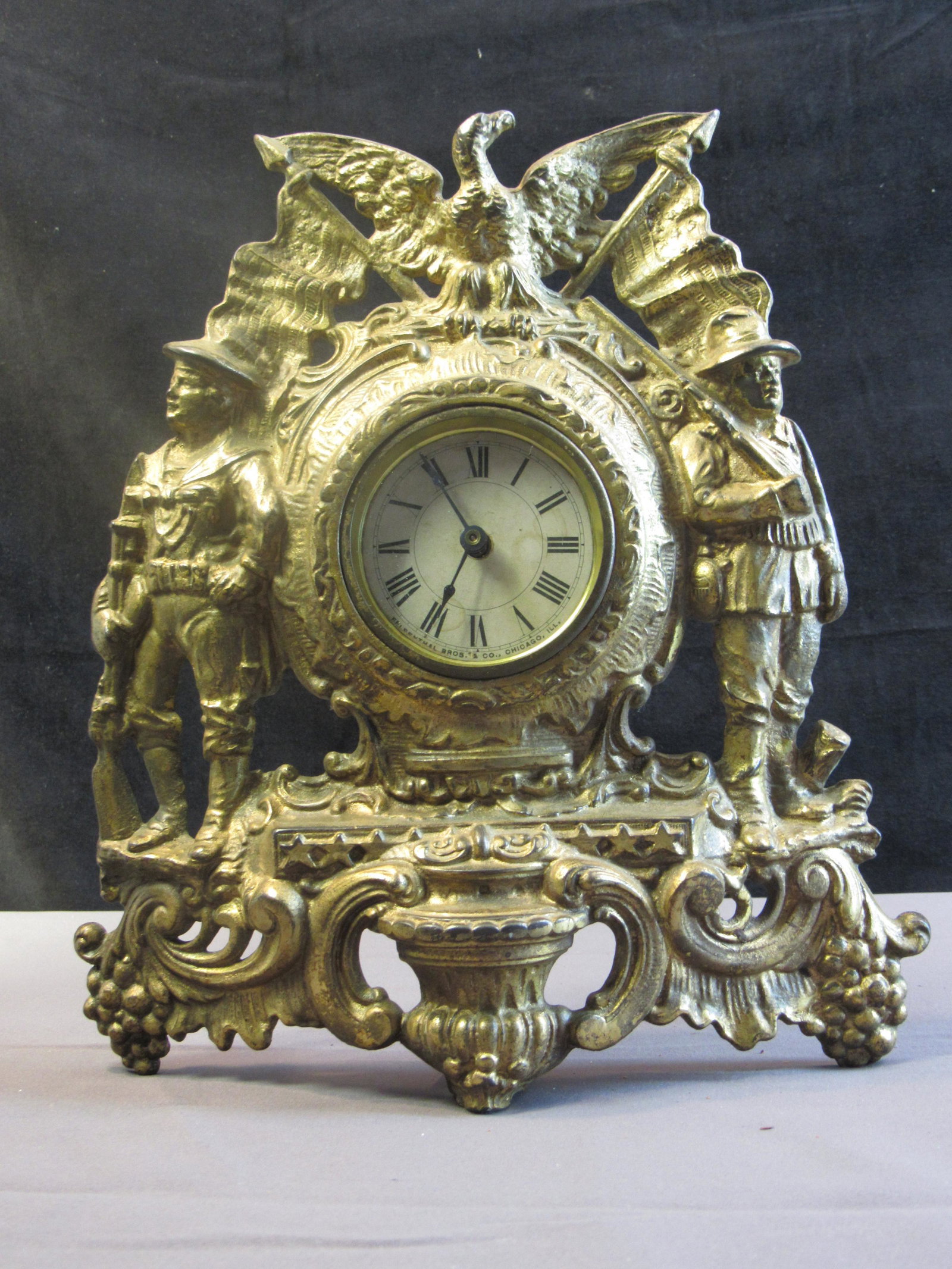 Felesanthal Warner Spanish American Commemorative Iron Front Clock: Felesanthal Warner Iron Front.Scene depicts soldiers from the Spanish American war. Antique clock. We had a hard time photographing this clock. The first photo most closely represents it tone.