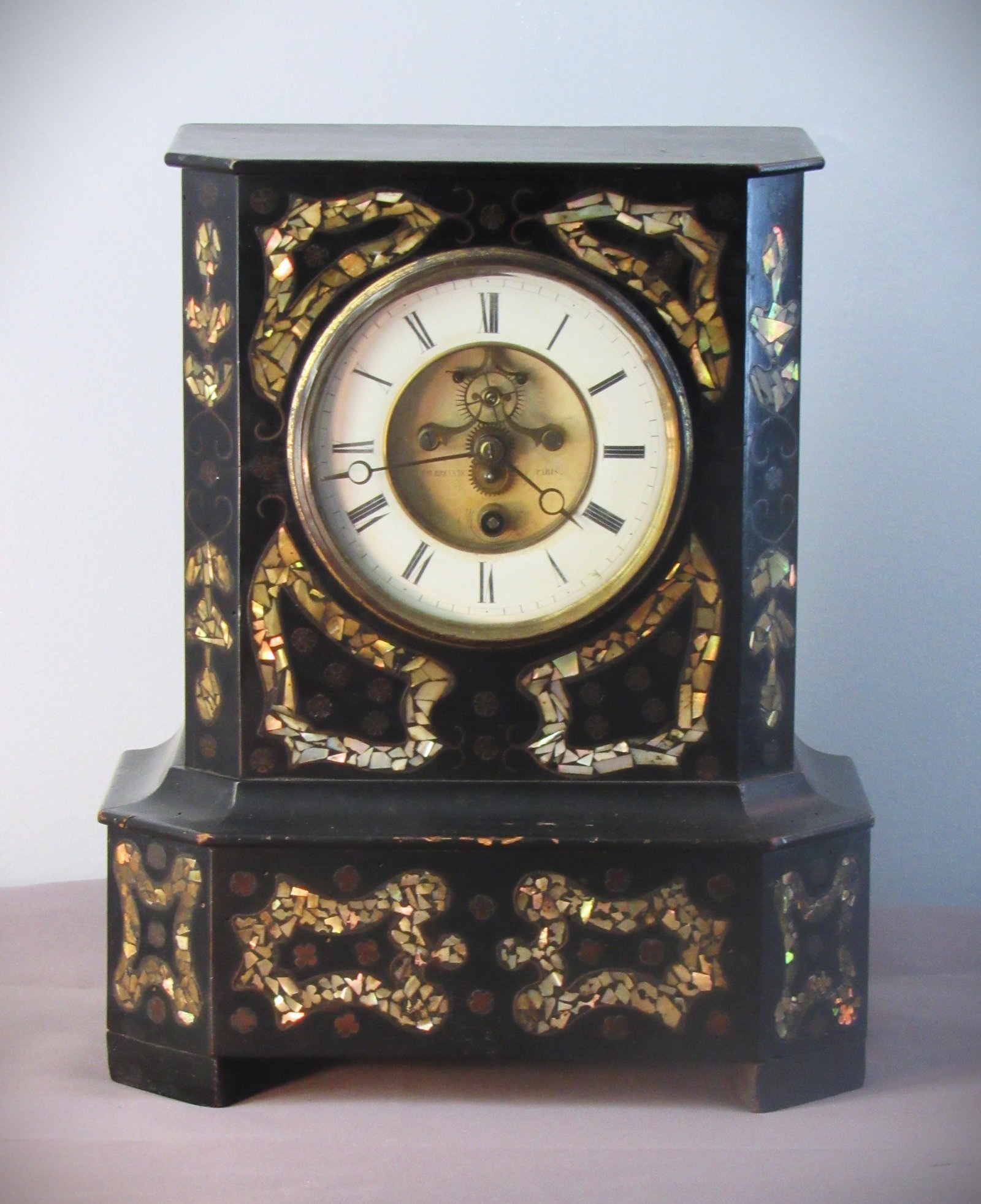 Brevete Paris Ebonized Wood Case with mother of Pearl French Clock: Brevete Paris Ebonized Wood Case with mother of Pearl French antique Clock. ~ This beautiful wood case from France made to look like a metal case or slate, with some minor loss or chips to the paint .