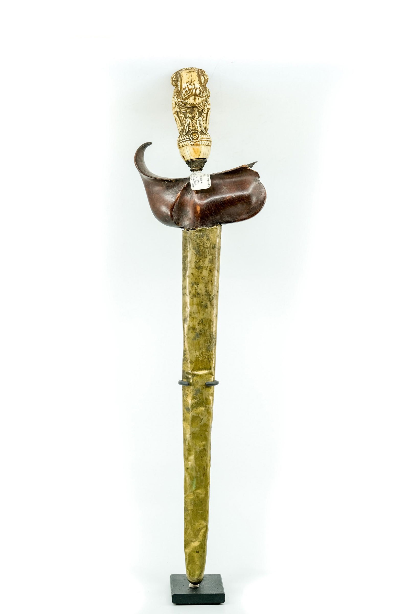 Antique Whale Tooth Madura Kris: Antique Whale Tooth Madura Kris, Damascus Steel, Carved Wooden Handle Shield, Carved Handle, Ornately Carved Handle. - Measurement: 19 3/4" x 5" Weight: 6 LBS.