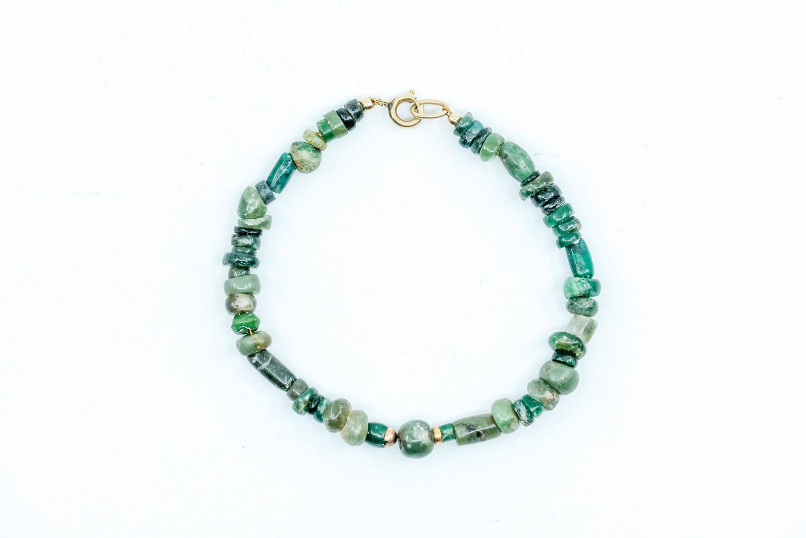 Pre-Columbian Mayan Jade Bead Bracelet: Pre-Columbian Mayan Jade Bead Bracelet, Various shapes and sizes of brilliant green Jade, Nice dainty bracelet, Gold clasp. - Measurement: 8" Long Weight: .4 OZ.