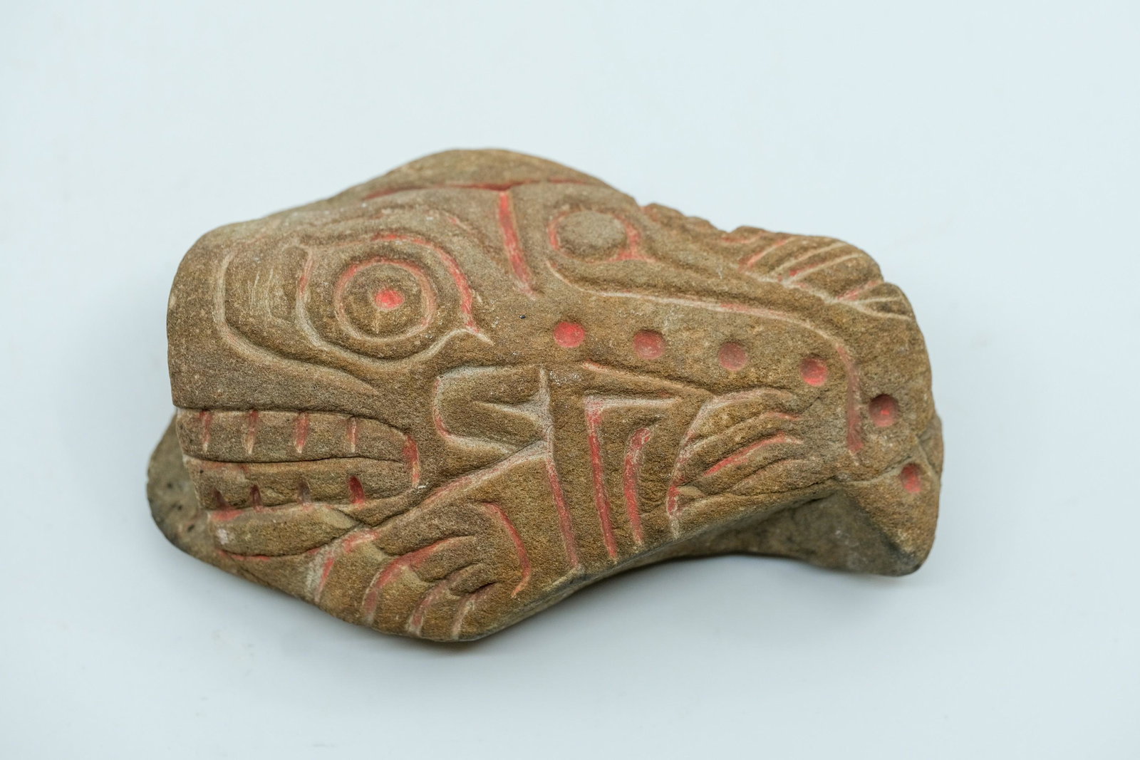 Pre-Columbian Mayan Zoomorphic Carved Stone: Pre-Columbian Mayan Zoomorphic Carved Stone, Traces of original cinnabar, Carved mouth, teeth, eyes, and hand. Measurements: 1 3/8" L x 3" W, Weight: 11.6 OZ.