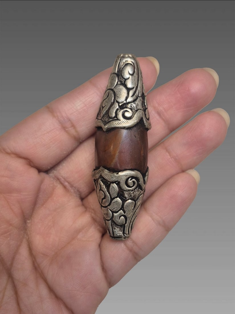 Antique Tibetan Amber Stone With Ornate Tibetan Silver Mounts Amulet: Antique Tibetan Amber Stone With Ornate Tibetan Silver Mounts Amulet Dimensions: 1"x2"