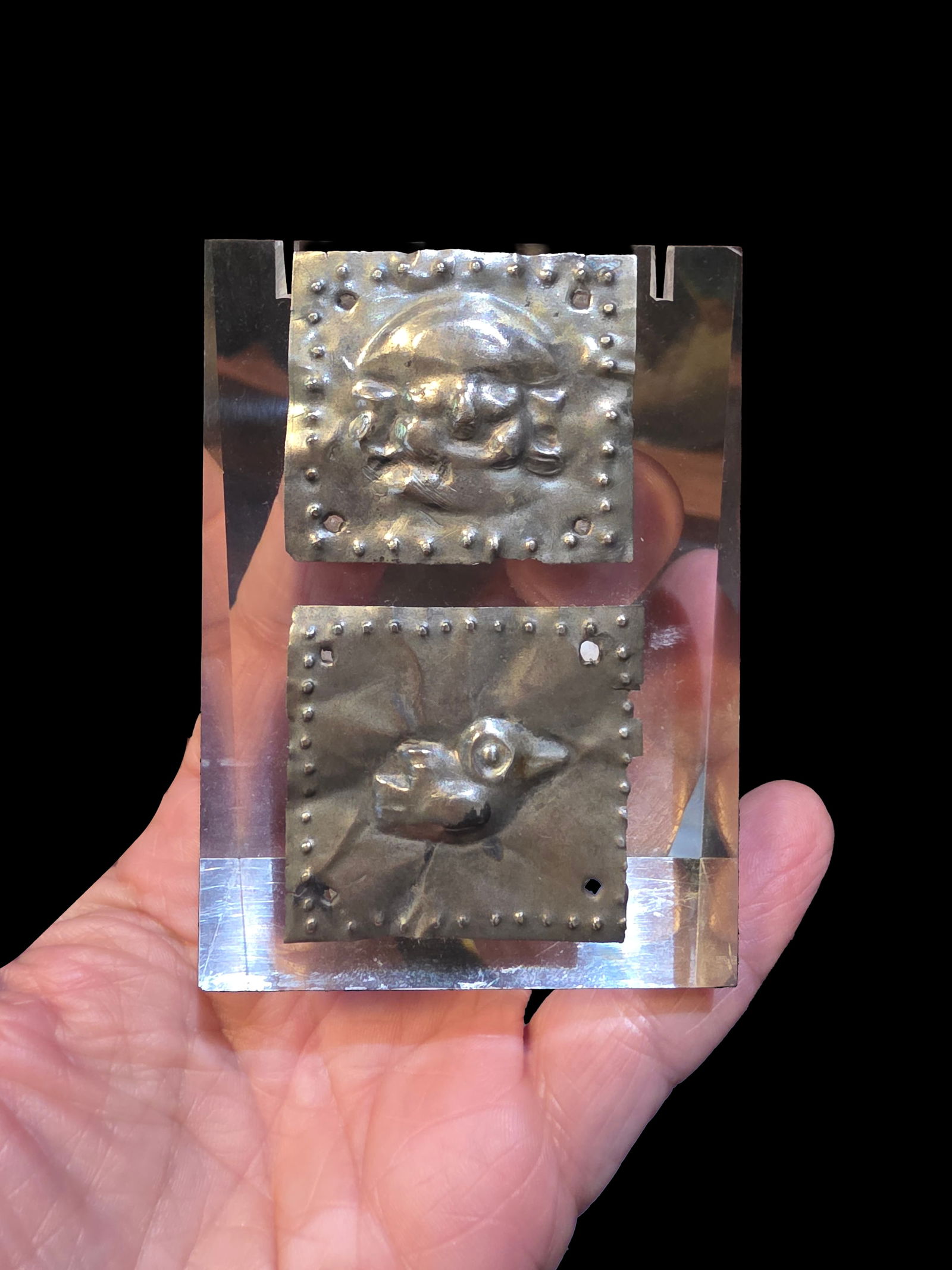 Pair of Pre-Columbian Moche Silver Relief Pendants: 1.5' x 1.5" Pair of Pre-Columbian Moche Silver Relief Pendants, Mounted on Acrylic Display Stand, Moche Culture, 100-800 A.D. , Each Pendant is 1.5' x 1.5"