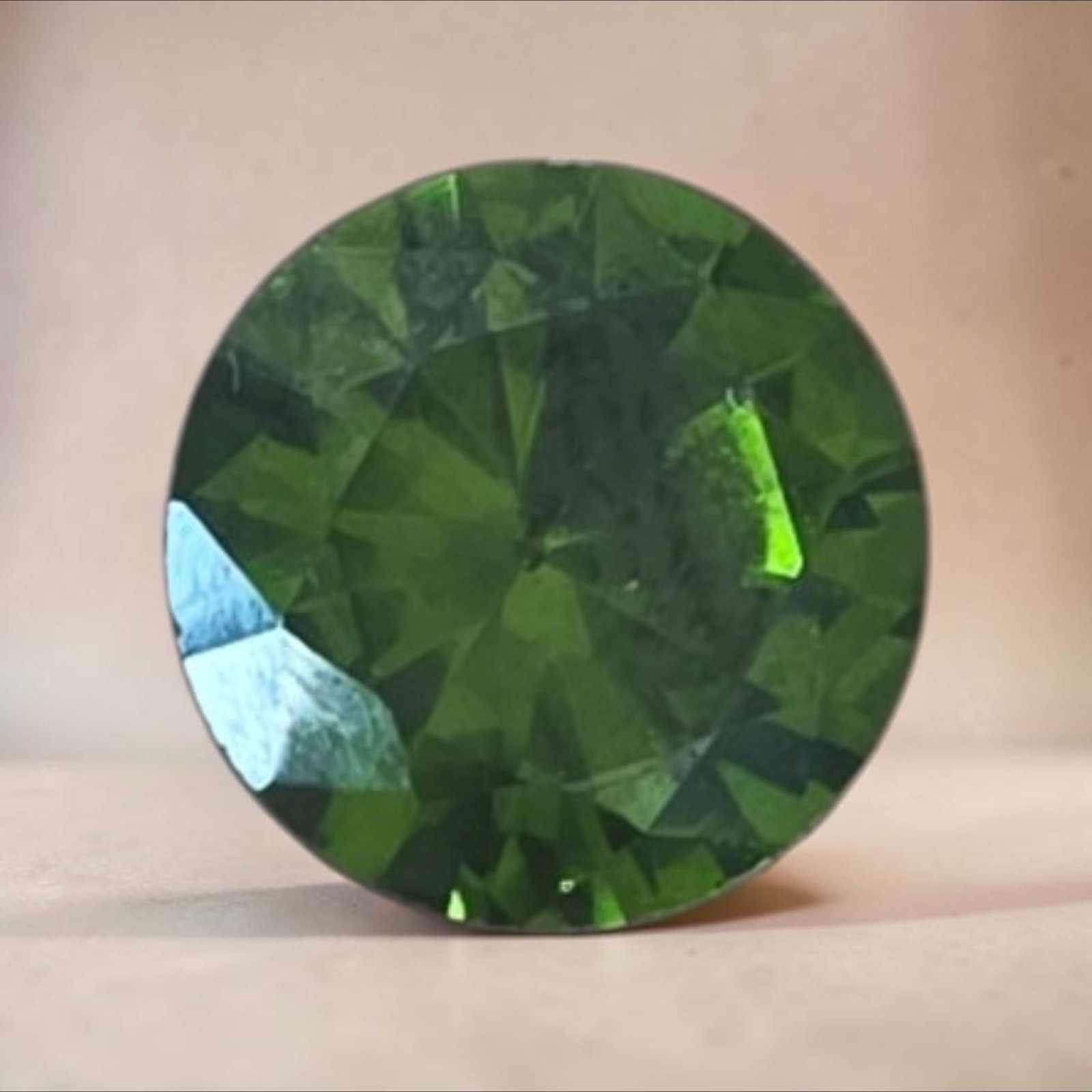 Green Faceted Gemstone: .25" Green Faceted Gemstone, Exact Material Unknown