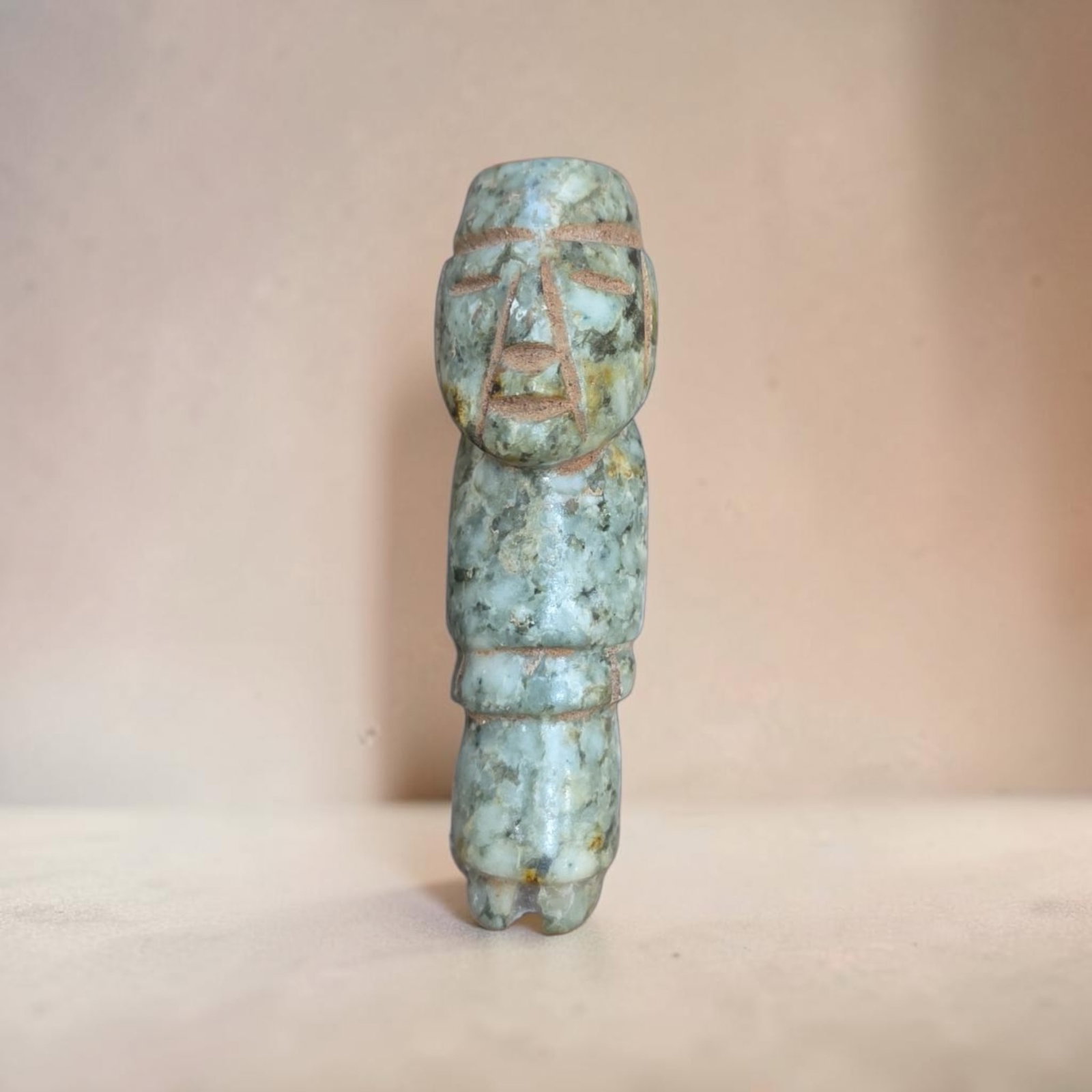 Pre-Columbian Jade anthropomorphic figurine bead: .5" x 2.5" Pre-Columbian Jade anthropomorphic figurine bead, Mottled blue-green jade, elongated head, stylized facial features, and rigid standing posture, Olmec Culture, 200 B.C.E.- 200 C.E.