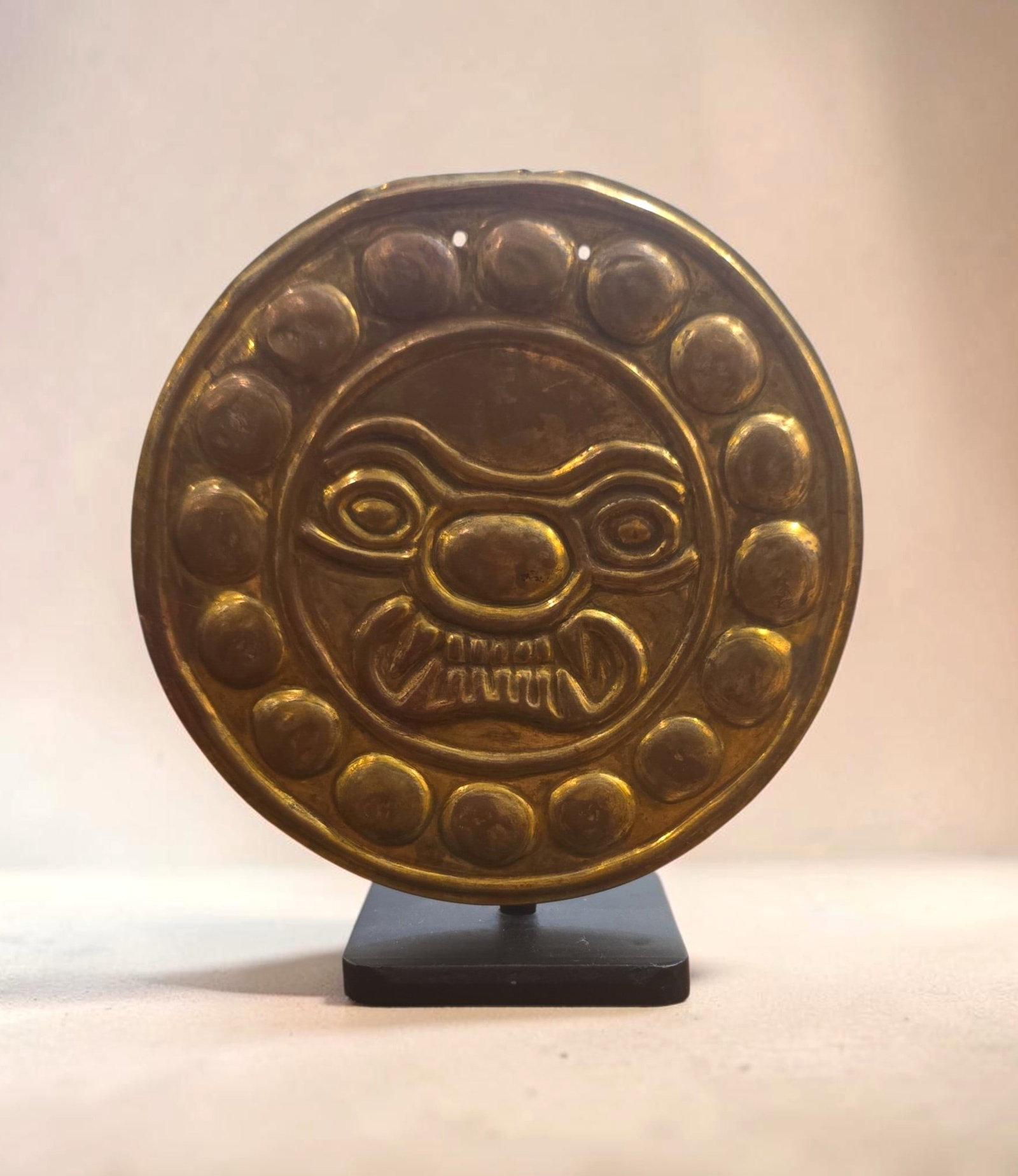 Pre-Columbian Tairona Snarling Jaguar Tumbaga Disc Pectoral: 4" Pre-Columbian Tairona Pectoral Tumbaga Disc, Gold Depletion Gilding, Snarling Jaguar Feline Face, wide eyes, stylized nose and bared teeth, Decorative bossing, sacred jaguar symbol, Repousse Techni