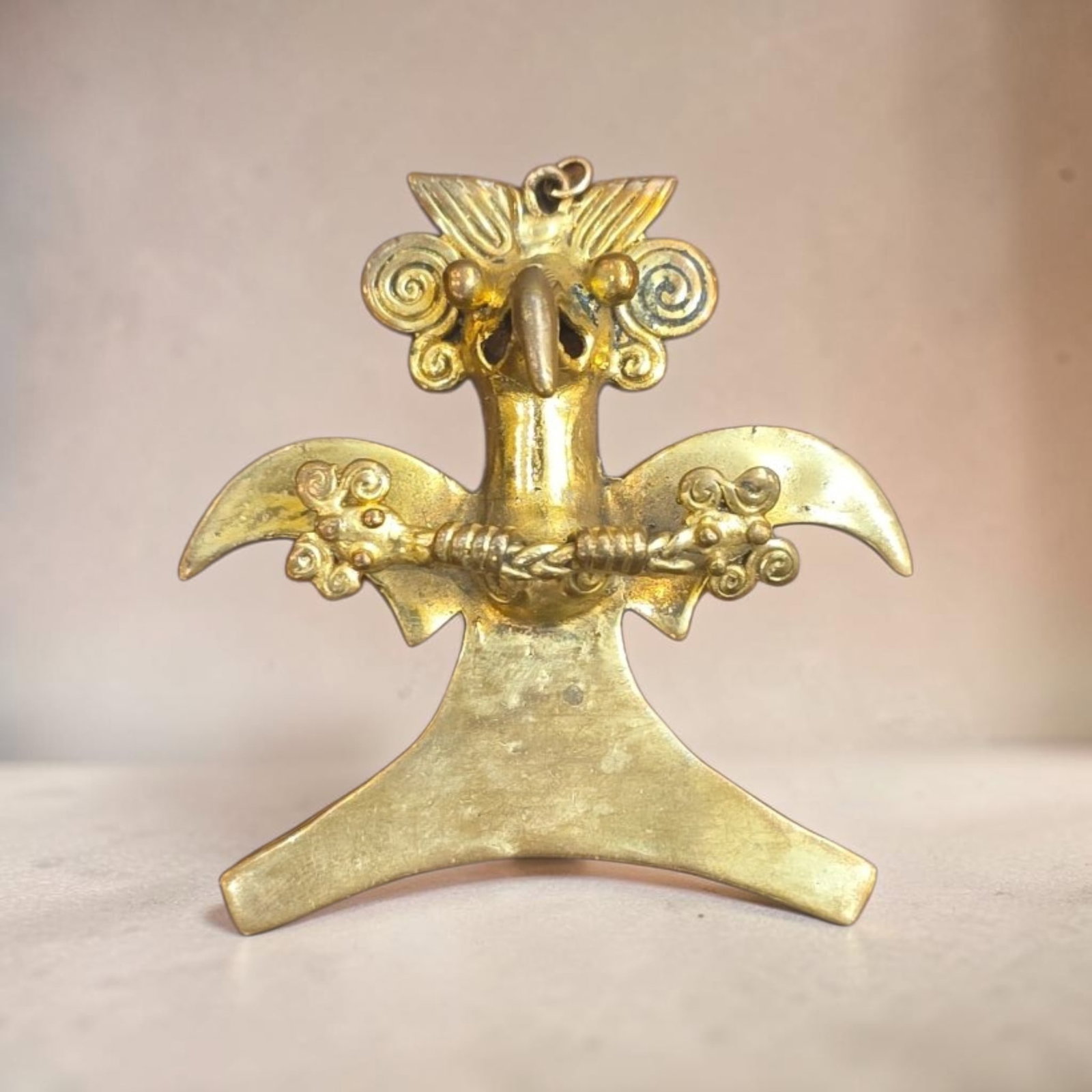 Pre-Columbian Gold Diquis Condor Pendant: 2" x 2.25" Pre-Columbian Gold Diquis Condor Pendant, Stylized Condor in Flight with outstretched wings and elaborate headdress holding a serpent, Costa Rica-Panama Region, 600-1400 C.E.